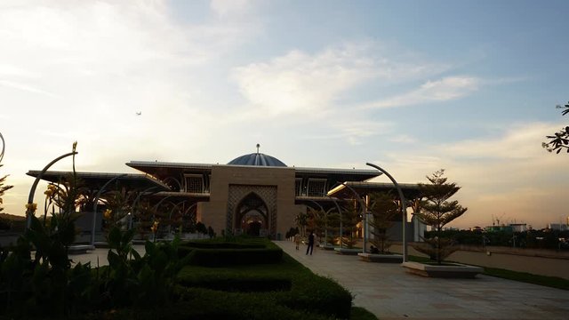 Beautiful sunset time lapse view of Tuanku Mizan Zainal Abidin Mosque or Iron Mosque by the Putrajaya lake in Putrajaya, Malaysia.Sky view PAN Upward