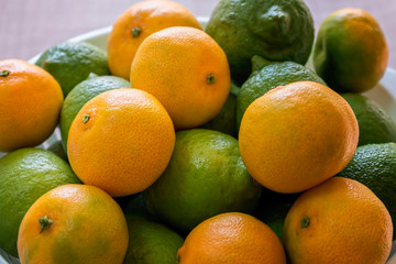 Bunch of Fresh Citrus. Mandarin Orange. Green Lemon