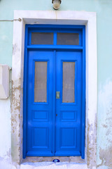 Fototapeta na wymiar Blue Door with Evil eye charm in Kastellorizo,Greece