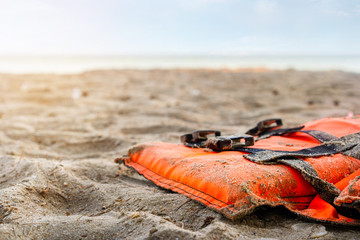 Close up of life jacket on the beach in sunrise, Selective focus.