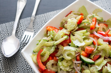 Healthy eating. Fresh vegetable salad in a white plate.