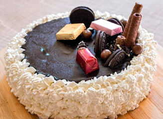 Homemade Cream Cake with Chocolate Fudge and sweets. Christmas New year. Events
