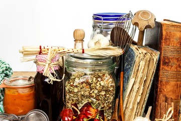 Kitchen utensils on a wooden table. White background. Food preparation. Cookbook and cooking ingredients. Old book