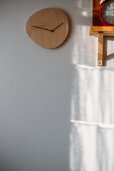 wooden clock on white wall