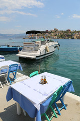 Fototapeta na wymiar Table and Chairs by the Sea in Kastellorizo,Greece