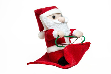 Doll Santa Claus on the sleigh on white background. merry christmas. Side