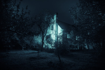 Mountain night landscape of building at forest at night with moon or vintage country house at night...
