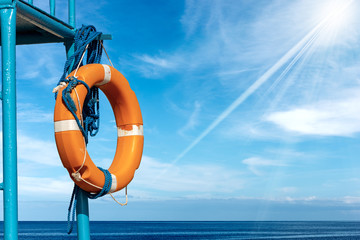 Orange Lifebuoy with Ropes on Lifeguard Chair