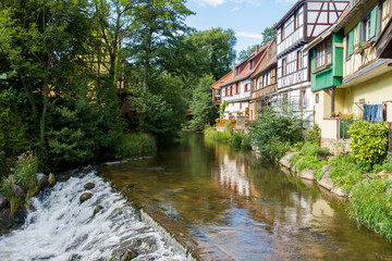 Fototapeta na wymiar French traditional half-timbered houses near La Weiss river in Kayserberg village in Alsace, France