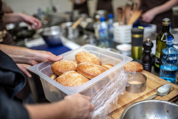 Hand hold a cheeseburger bun