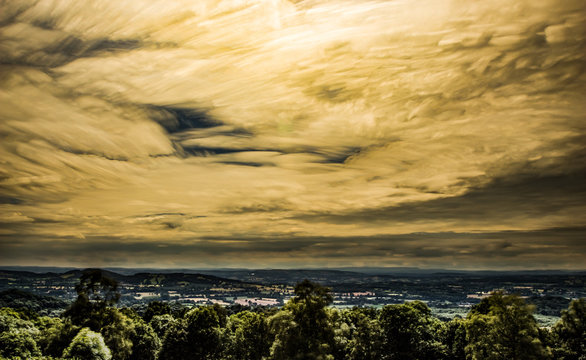 timelapse movement of clouds across wood land and far reaching scenic landscape