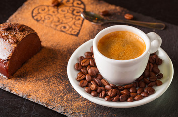 Chocolate cake and espresso coffee on a slate background.