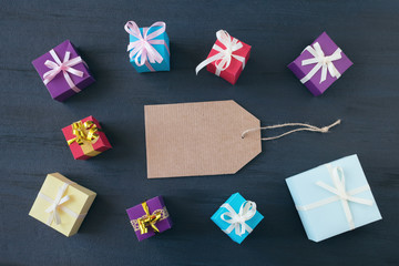 Shopping banner mockup with cardboard label and gift boxes on dark background. Black Friday sale shopping concept. Flat lay