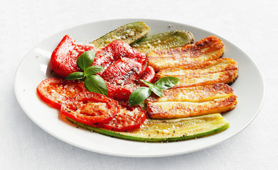 fried halloumi cheese and roasted vegetables flavoured with olive oil, vinegar, and garlic sprinkled with black pepper and decorated with basil