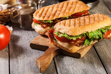 Toasted ciabatta sandwich with smoked bacon, cheese and tomato