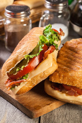 Toasted ciabatta sandwich with smoked bacon, cheese and tomato