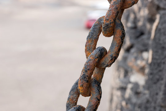 Closeup rusty chain link. Closely and inseparably connected