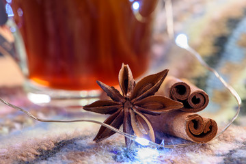 Star anise, cinnamon sticks, cup of tea.  Spices for winter hot drinks.