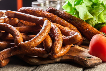 Assorted smoked sausages on a cutting board