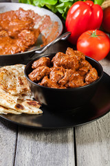 Chicken tikka masala served with bread naan