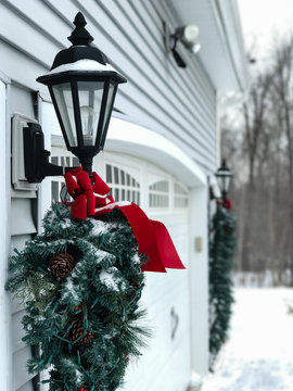 Outdoor Christmas Greener with Red Bow in Snow