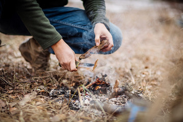 meat on the stick grilled in the fire. bushcraft concept