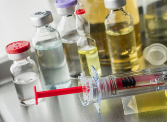 Several syringes and vials in a laboratory in a hospital, conceptual image