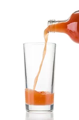 Fresh fruit juice pouring into glass isolated on white background