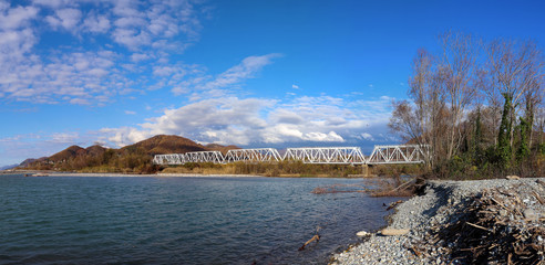 panorama of bridge over the river flowing into the sea