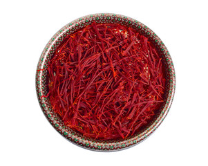Delicate saffron threads, plucked from crocus flowers and dried. In the ethnic box. Isolated on...