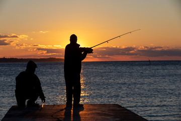 two fishermen in the sunset