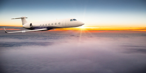 Fototapeta na wymiar Private jet plane flying above dramatic clouds.