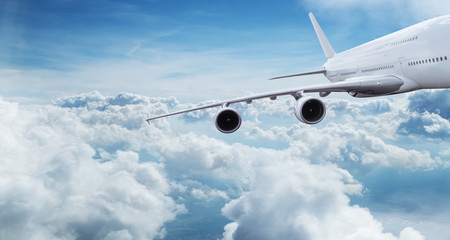 Fototapeta na wymiar Big airplane flying above dramatic clouds.