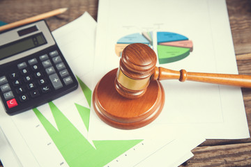 wooden gavel and calculator