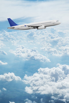 Fototapeta Commercial airplane flying above dramatic clouds.
