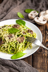 delicious spaghetti dish with spinach sauce and mushrooms
