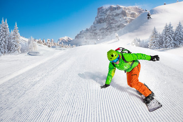 Man snowboarder riding on slope.