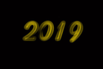  illustration: Hand drawn brush stroke golden paint lettering of 2019. Happy New Year . 2019 number dark background text. Yellow color