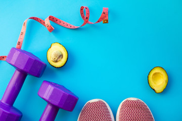 Fitness equipment dumbbells on color background. Flat lay.