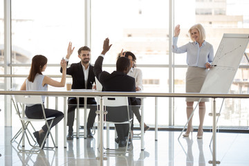 Happy diverse business people team interns group and mature mentor coach raising hands at office...