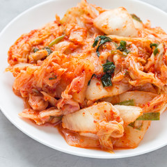 Kimchi cabbage. Korean appetizer on a white plate, square