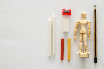 Top view of artist art supplies over white canvas background. Copy space.