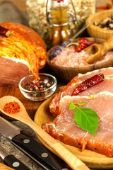 Pork chop on old wooden table. Raw meat and spices. Marinated pork meat on grill
