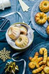 italian homemade flat bread with tomato, feta cheese, ham, and basilic, on  a round cutting board over a black board, flat lay with knife and red wine .
