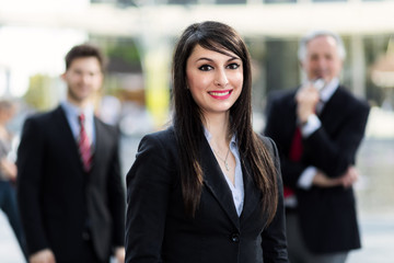 Business team smiling outdoor in a modern urban setting