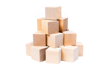 Light yellow wooden cubes on white background. Isolated on white. Business, finance, education
