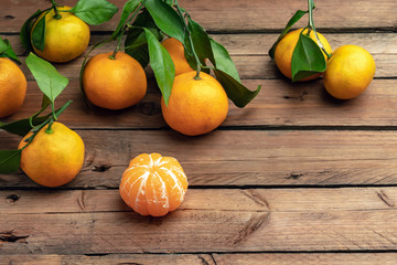 orange tangerines with leaves on a wooden background, new year