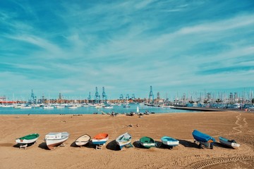 one of the city sandy beaches next to the harbor and marina with sailing yacht boats anchoring in the small bay and fishing dinghies