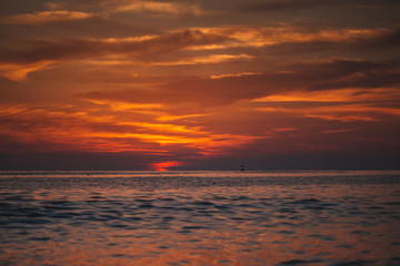 Fototapeta na wymiar Warm beautiful evening sunset above sea, Cleopatra's beach in Alanya, Turkey