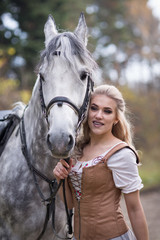 Obraz premium Young woman with a horse